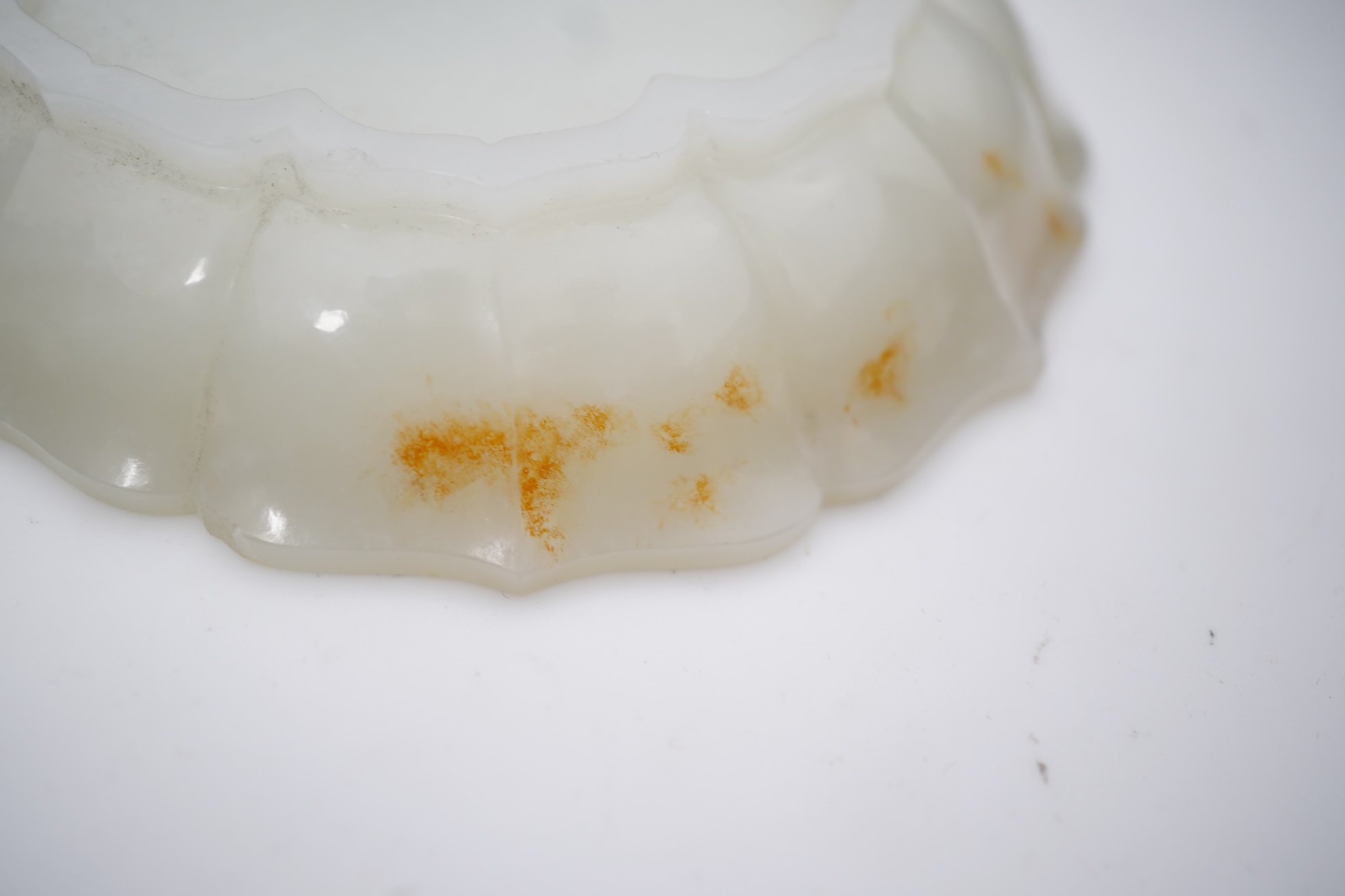 A Chinese white and russet jade petal lobed cup stand